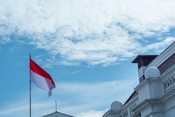 Red and white flag with blue sky. Indonesia nation flag with beautiful morning sky