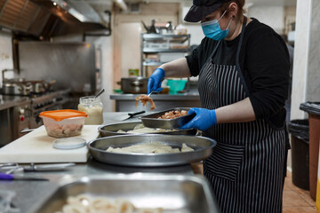 Preparing food for take away at kitchen