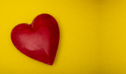 Fototapeta premium Red color heart shape box on yellow banner