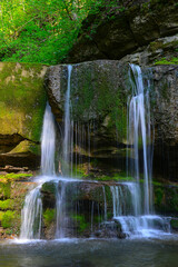 Waterfall in the sunny summer forest of the Caucasus