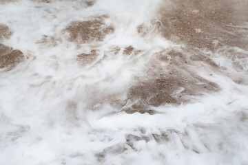 liquid nitrogen spilled on the ground, close-up view of steam