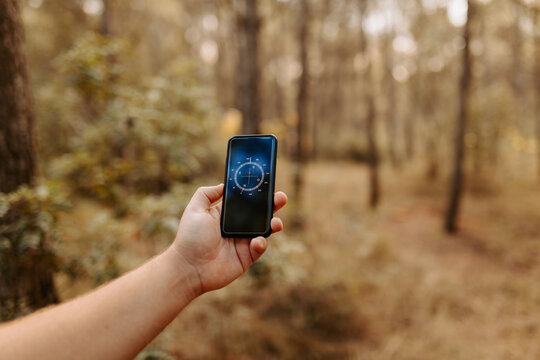 Anonymous person using smartphone app to look at compass