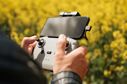 Close up of a man's hands with the remote control of a drone