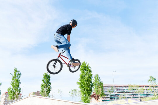 Teen doing a tail whip on his BMX