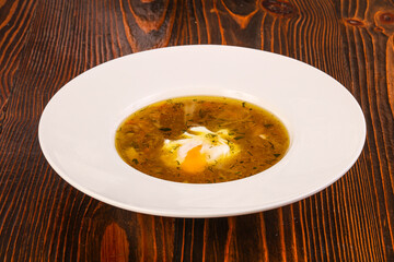 Chicken soup with poached egg