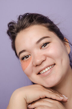 Young brunette east asian woman wearing  skincare under eye patch