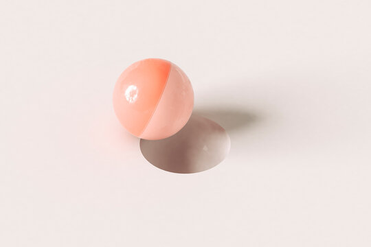 Pink sphere in balance near a hole