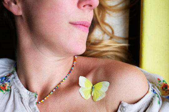 Butterfly on Woman's Shoulder