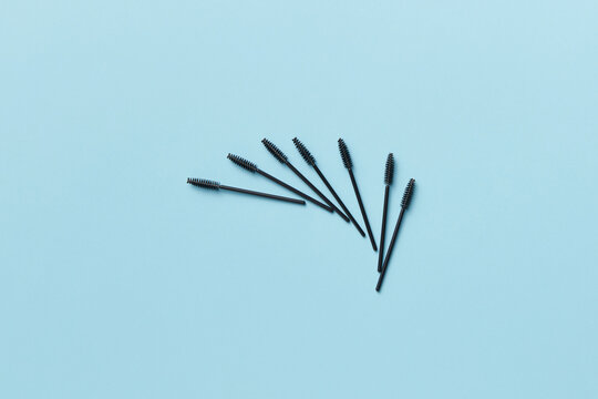 Mascara brushes on blue background