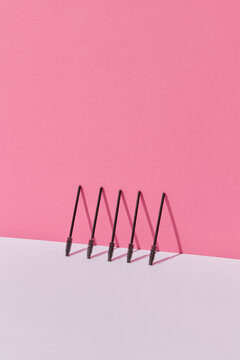 Mascara brushes on pink background