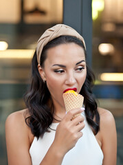 Happy Woman eating a delicious ice cream cone in vacation travel