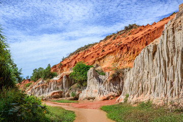 Red Sand Dunes and blue sky and brook in Mui Ne village in Vietnam