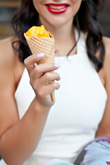 Happy Woman eating a delicious ice cream cone in vacation travel
