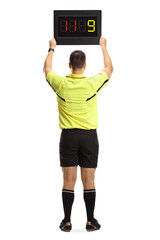 Rear view of a football referee holding a substitute board