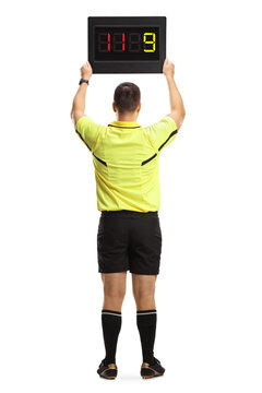 Rear View Of A Football Referee Holding A Substitute Board