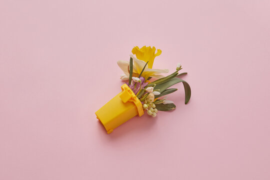 Snowdrops and daffodil in trash can