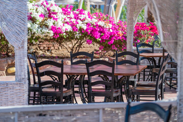Wooden table and chairs in beach cafe next to the red sea in Sharm el Sheikh, Egypt
