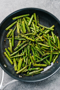 Sauteed asparagus in a frying pan