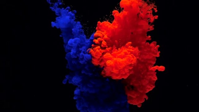 Ink in water. Slow motion blue and red ink drops in water and mixes, swirling softly underwater on black background. Slowmotion acrylic cloud paint in aquarium. Abstract smoke explosion animation