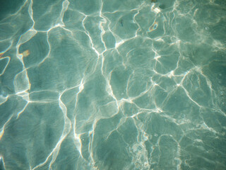 blue, clear and transparent sea water with sun glare