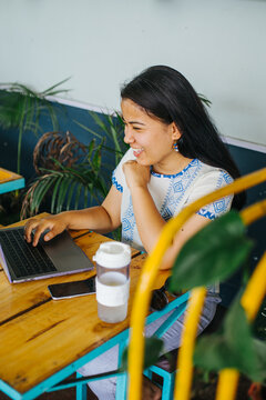 Young southasian woman freelancer smiling at the laptop 