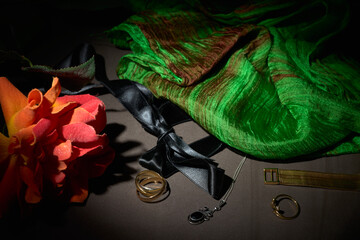 A brooch with chain, several rings, a bracelet and a shawl