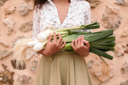Anonymous woman holding vegetables