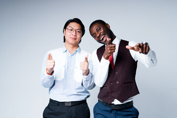 Happy african american and asian business people smiling and throwing thumbs up while looking at the camera