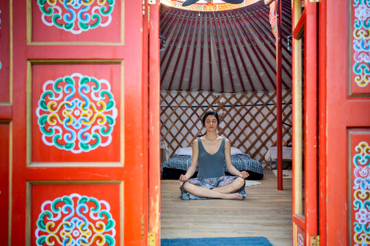 Hippie Woman Doing Meditation In A Yurt. 
