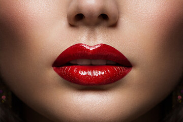 Red Lips Close up. Woman Beauty Face Make up. Glossy Shiny Lipstick Cosmetic. Model with Plump Lips...