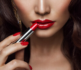 Beauty Model applying Red Lipstick. Perfect Lips Make up and Nail Polish Close up. Glamour Face...