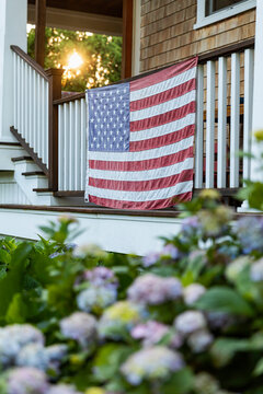 American Flag hanging on Porch with Hydrangea Flowers 