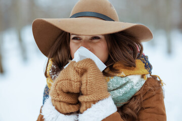 stylish woman outside in city park in winter