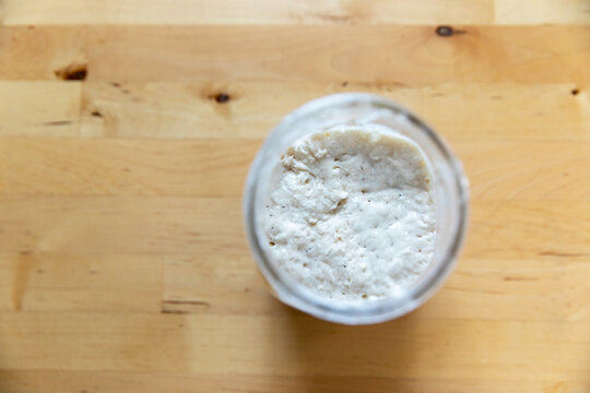 Jar of Sourdough Starter on Wooden Table
