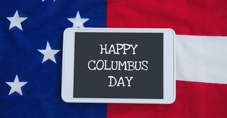 Happy columbus day text on digital tablet against american flag in background
