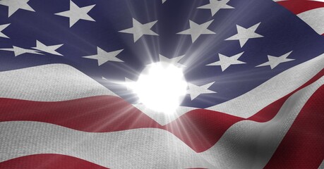 Bright spot of light against waving american flag