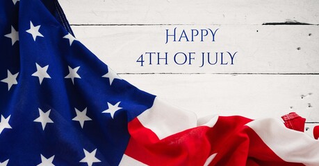 Happy independence day text and waving american flag against wooden background