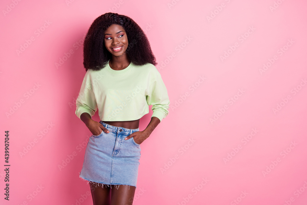 Sticker Photo of attractive pretty sweet afro american woman hold hands pockets look empty space isolated on pink color background