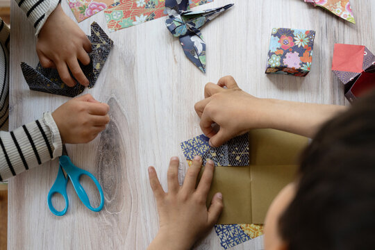 Kids doing origami 