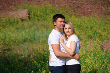 Young beautiful couple hand by hand on natural background.