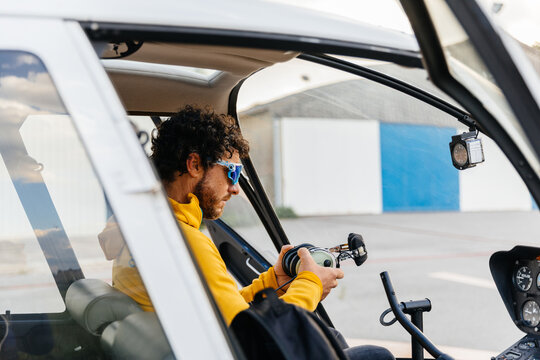 Helicopter pilot with sunglasses preparing to fly