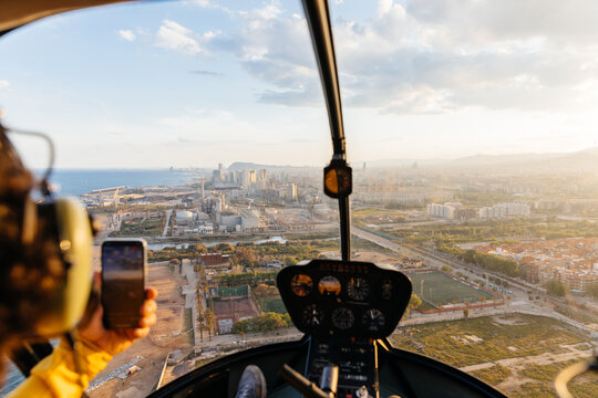 Helicopter passenger taking photos with his mobile