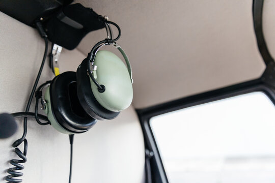 Headphones hanging from the ceiling of a helicopter
