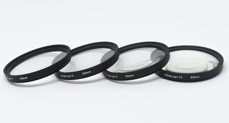 Macro camera lens, close-up, +1 +2 +4 +10, white infinity background.