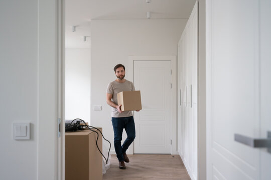Man Carrying Carton Box Indoors