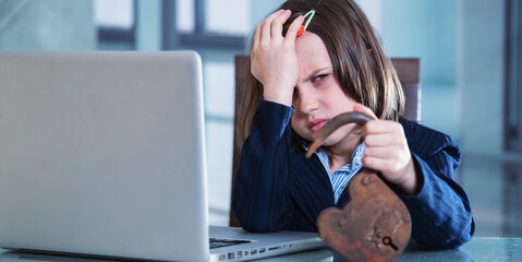 Stressed business child girl having problem with pc laptop. She holding open lock as symbol of...