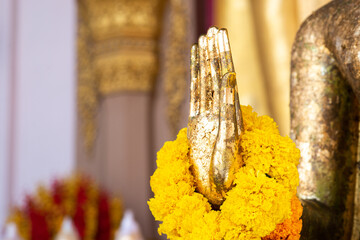 Buddha statue with raw of Brass. Hand of buddha statue with. marigold garland and rose garland....