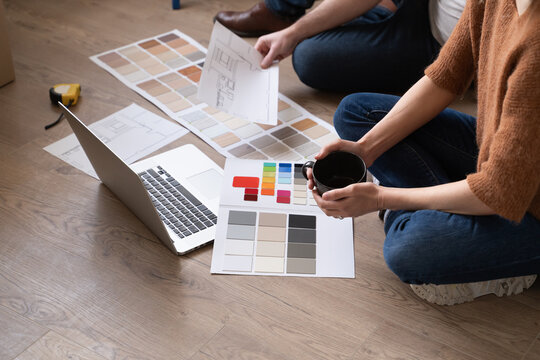 Couple Looking Colour Chart And Laptop