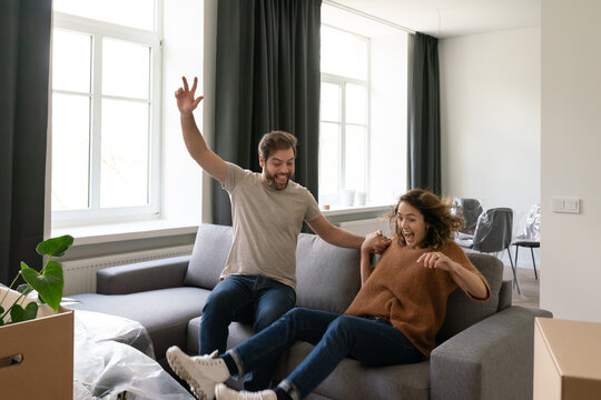 Couple Having Fun Relocating To New Apartment