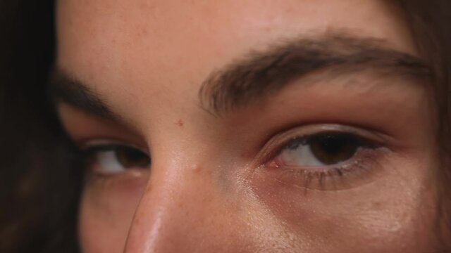 Close up of Woman eyes, Girl opening her Beautiful brown eyes. Natural Beauty. Gorgeous woman with long Eyelashes and Attractive Appearance. Slow motion.